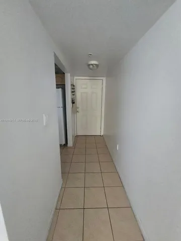 a view of a livingroom with an empty space and a window