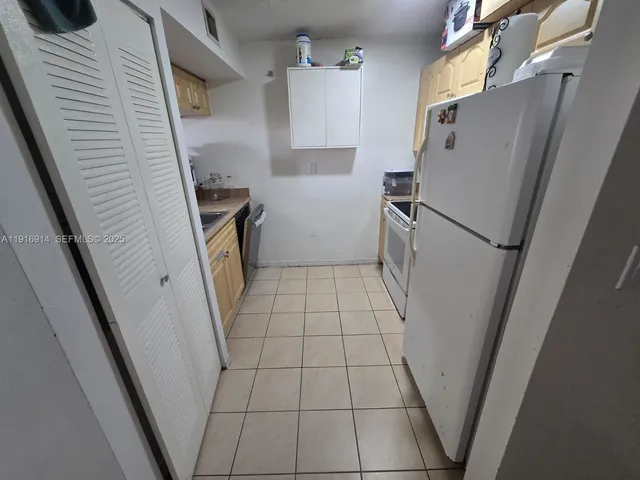 a utility room with cabinets washer and dryer
