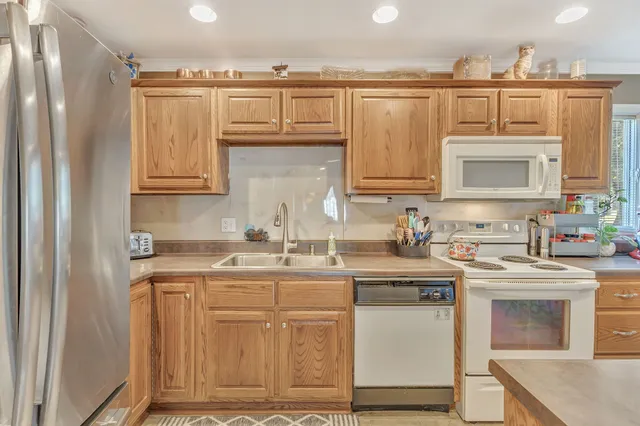 a kitchen with stainless steel appliances granite countertop a sink and cabinets