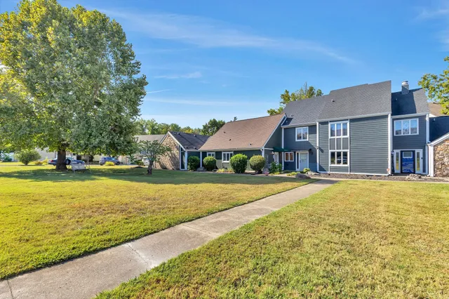 a front view of house with yard and lake view