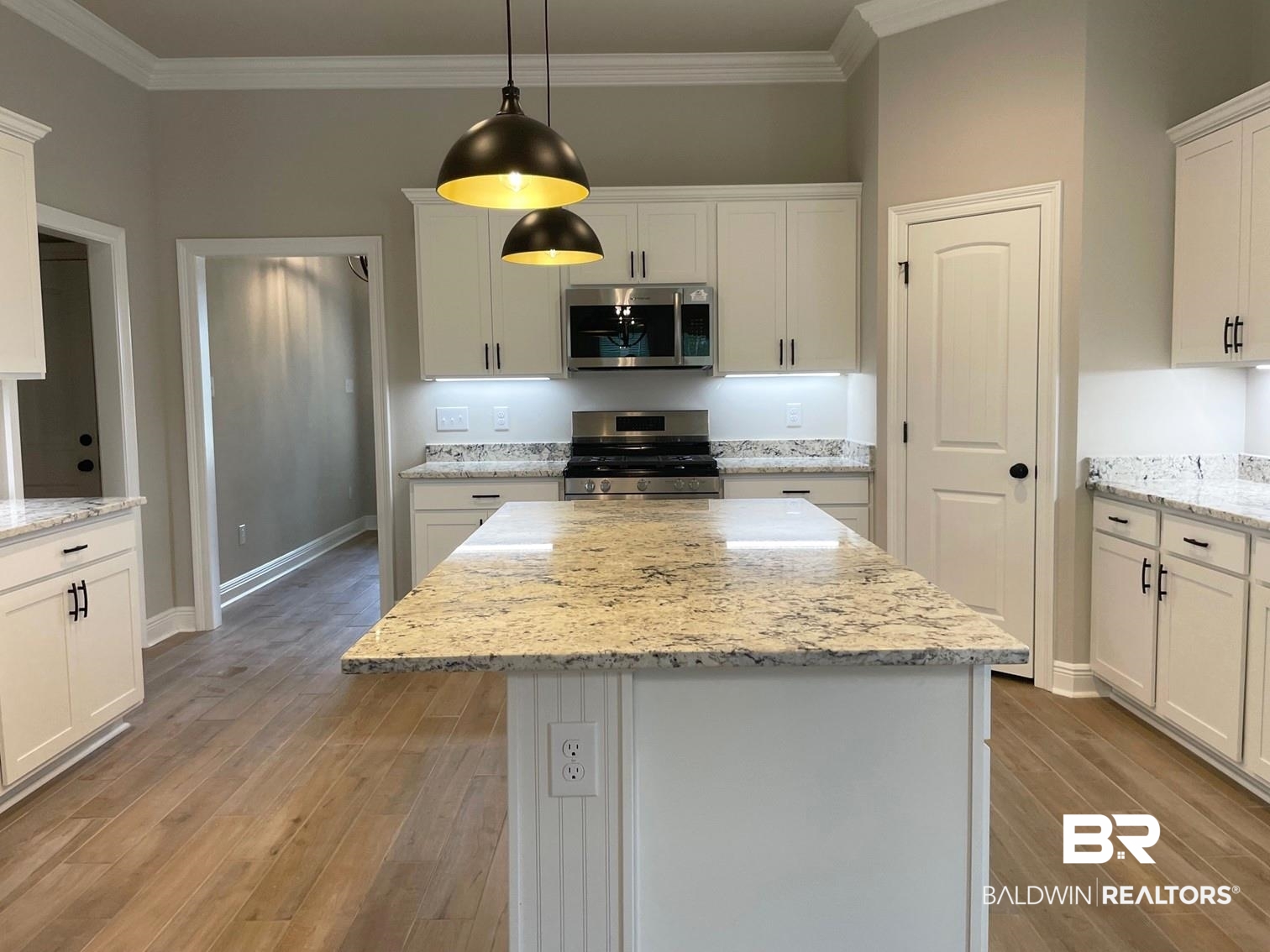 1412 Fenton Circle Foley, AL 36535 - Photo 3 of 15 Kitchen featuring light wood-type flooring, white cabinetry, a center island, and stainless steel appliances