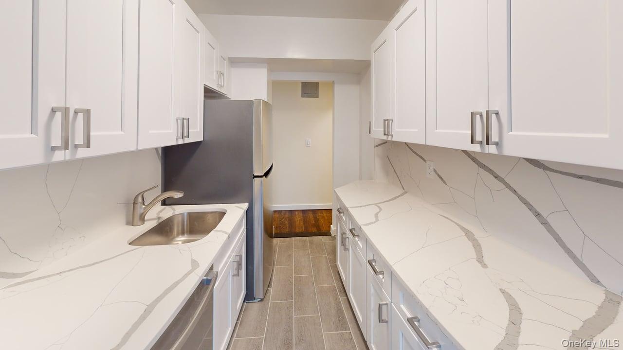 678 Warburton Avenue, Unit 6L Yonkers, NY 10701 - Photo 2 of 14 a kitchen with a sink and a refrigerator