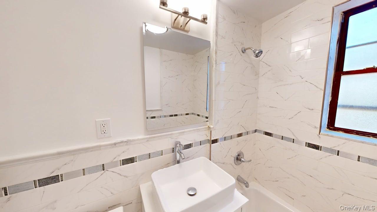678 Warburton Avenue, Unit 6L Yonkers, NY 10701 - Photo 4 of 14 a bathroom with a bathtub and a sink