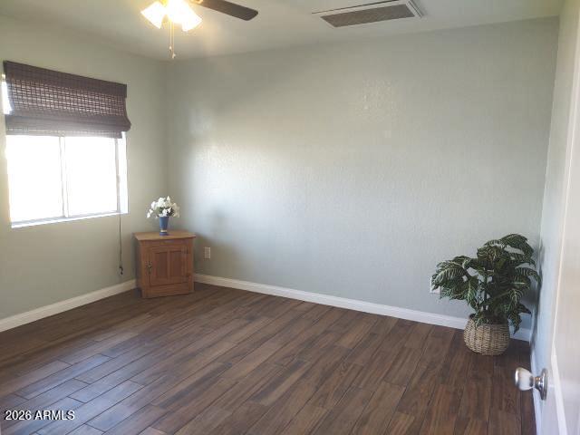 308 South 3rd Street Buckeye, AZ 85326 - Photo 14 of 37 an empty room with wooden floor and windows