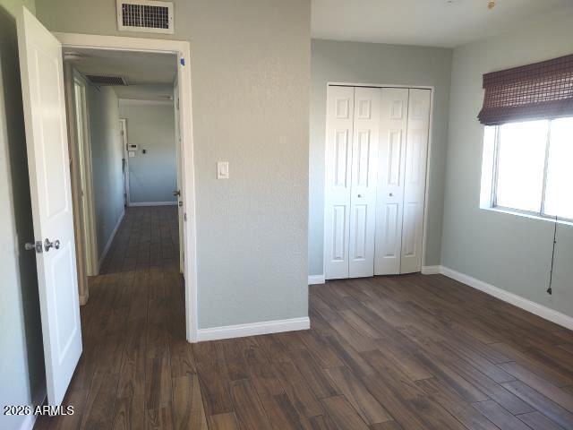 308 South 3rd Street Buckeye, AZ 85326 - Photo 15 of 37 an empty room with wooden floor and windows
