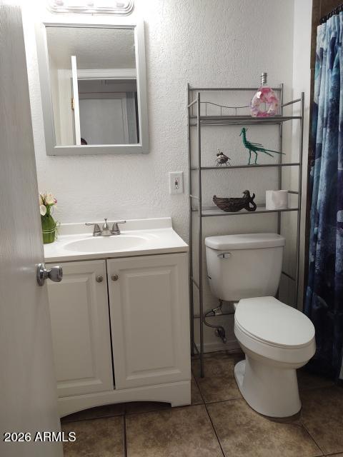 308 South 3rd Street Buckeye, AZ 85326 - Photo 18 of 37 a bathroom with a toilet sink and mirror