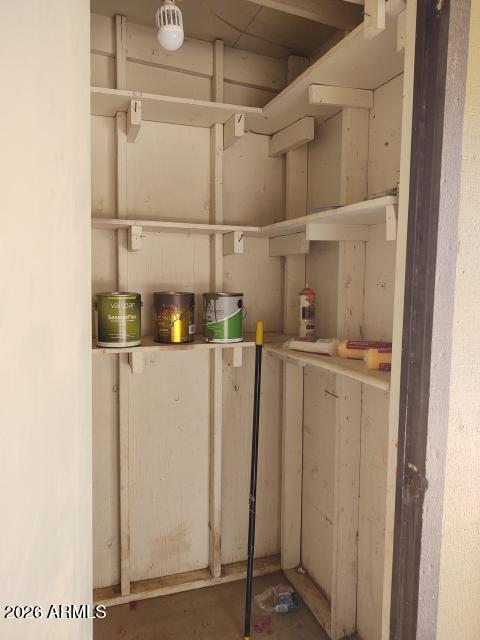 308 South 3rd Street Buckeye, AZ 85326 - Photo 27 of 37 a view of storage and utility room with racks on the wall