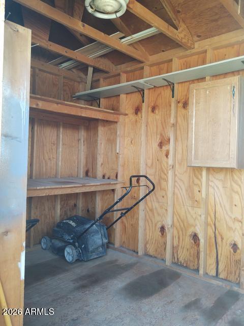 308 South 3rd Street Buckeye, AZ 85326 - Photo 29 of 37 a room with water heater and a wooden cabinets