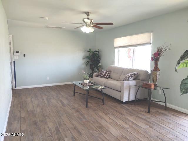 308 South 3rd Street Buckeye, AZ 85326 - Photo 6 of 37 a living room with furniture and a wooden floor