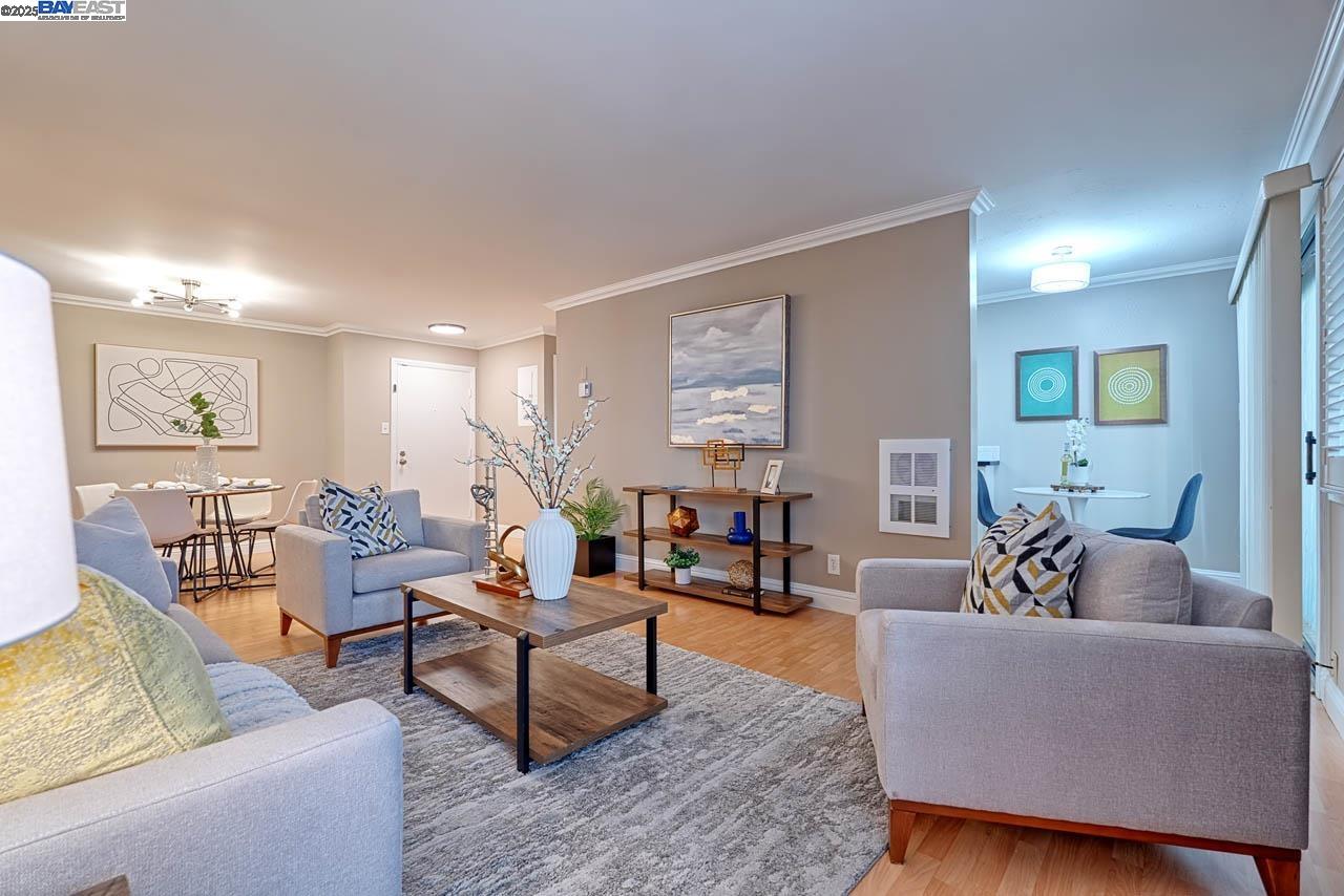 a living room with furniture and wooden floor