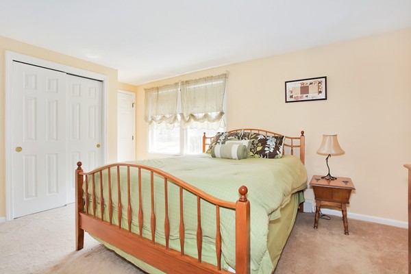 11 Robbins Road Ayer, MA 01432 - Photo 14 of 30 a bedroom with a bed and a table in it