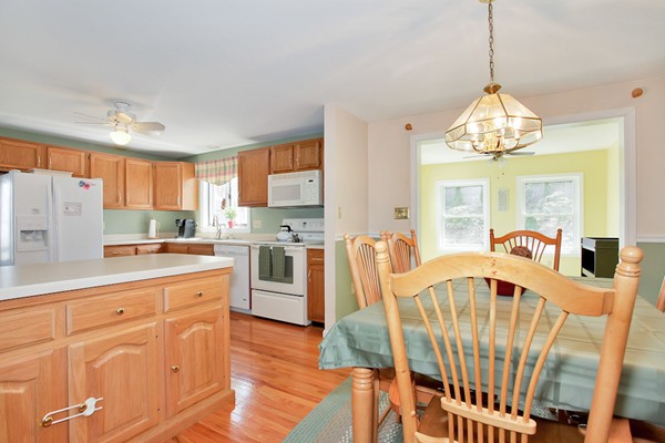 11 Robbins Road Ayer, MA 01432 - Photo 5 of 30 a dining room with furniture a chandelier and wooden floor
