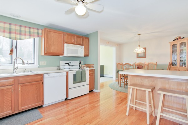 11 Robbins Road Ayer, MA 01432 - Photo 8 of 30 a kitchen with a table chairs sink and cabinets