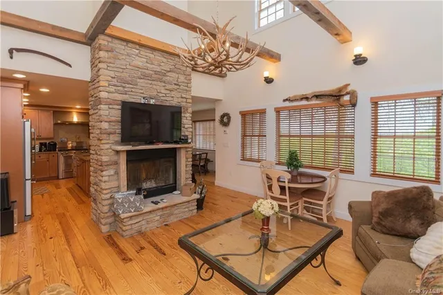 a living room with furniture a flat screen tv and a fireplace