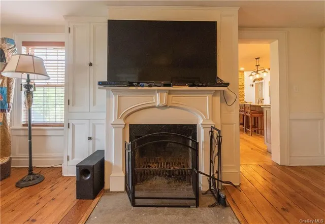 a living room with a fireplace and a flat screen tv