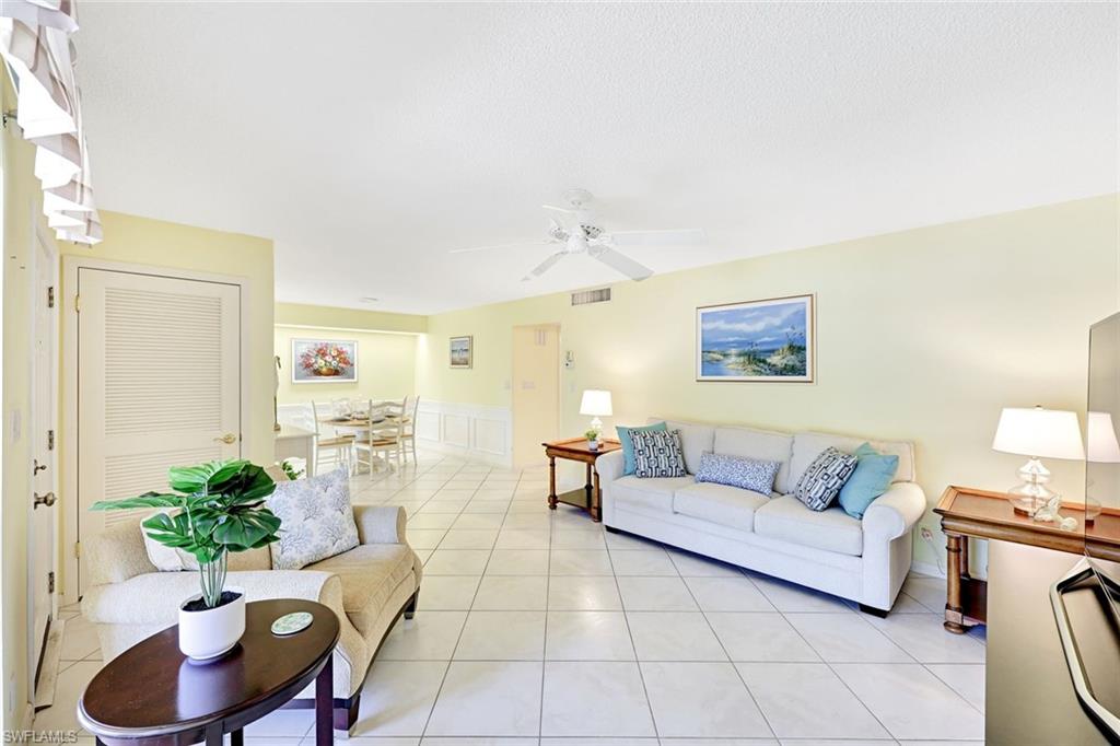 2000 Alamanda Drive, Unit 104 Naples, FL 34102 - Photo 19 of 32 a living room with furniture and a potted plant