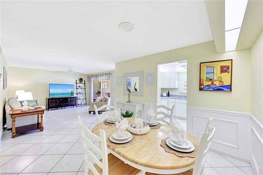 2000 Alamanda Drive, Unit 104 Naples, FL 34102 - Photo 21 of 32 a view of a dining room with furniture and wooden floor