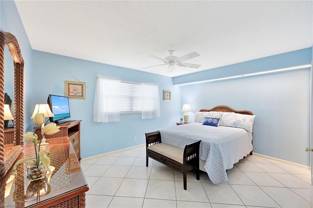 2000 Alamanda Drive, Unit 104 Naples, FL 34102 - Photo 26 of 32 a bedroom with a bed and window