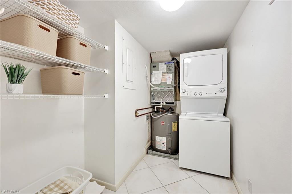 2000 Alamanda Drive, Unit 104 Naples, FL 34102 - Photo 31 of 32 a utility room with dryer and washer