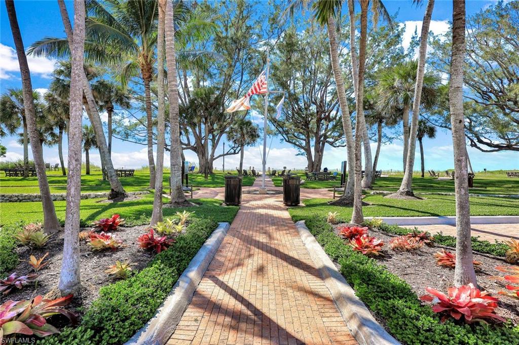2000 Alamanda Drive, Unit 104 Naples, FL 34102 - Photo 7 of 32 a park view with potted plants and large trees