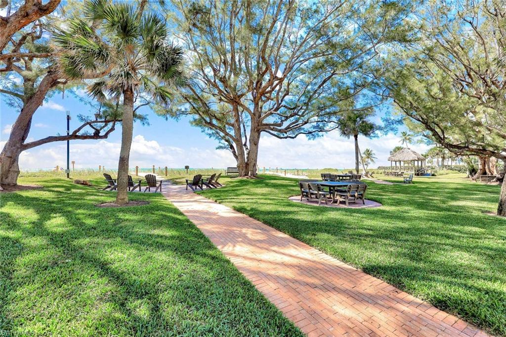 2000 Alamanda Drive, Unit 104 Naples, FL 34102 - Photo 8 of 32 a view of a park with large trees