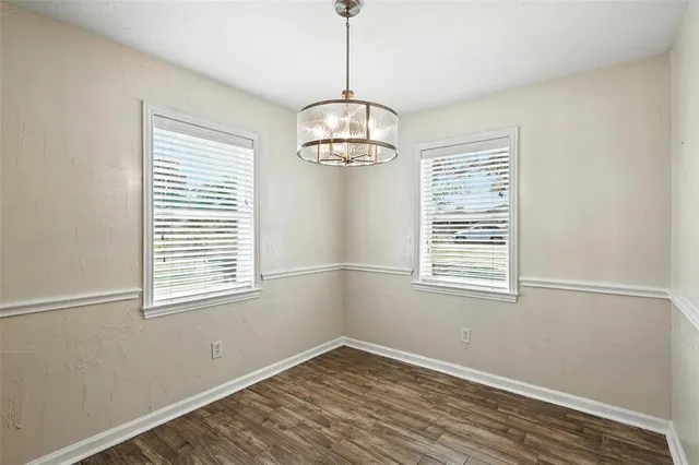 a kitchen with stainless steel appliances granite countertop a dining table chairs and granite counter tops