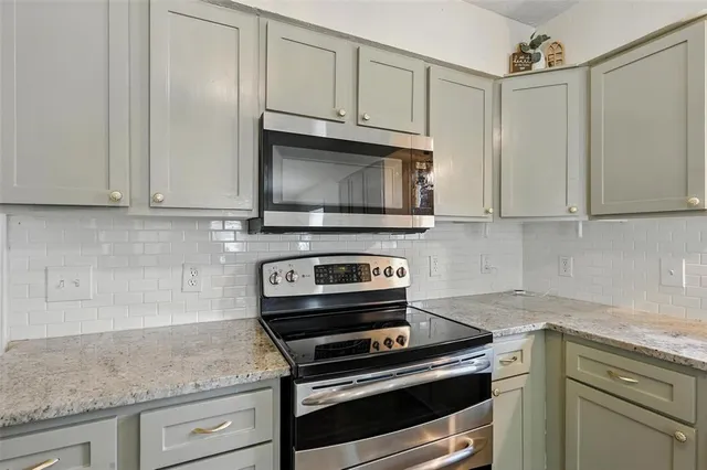 a kitchen with stainless steel appliances a stove sink and microwave