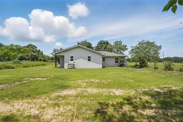a front view of a house with swimming pool having outdoor seating