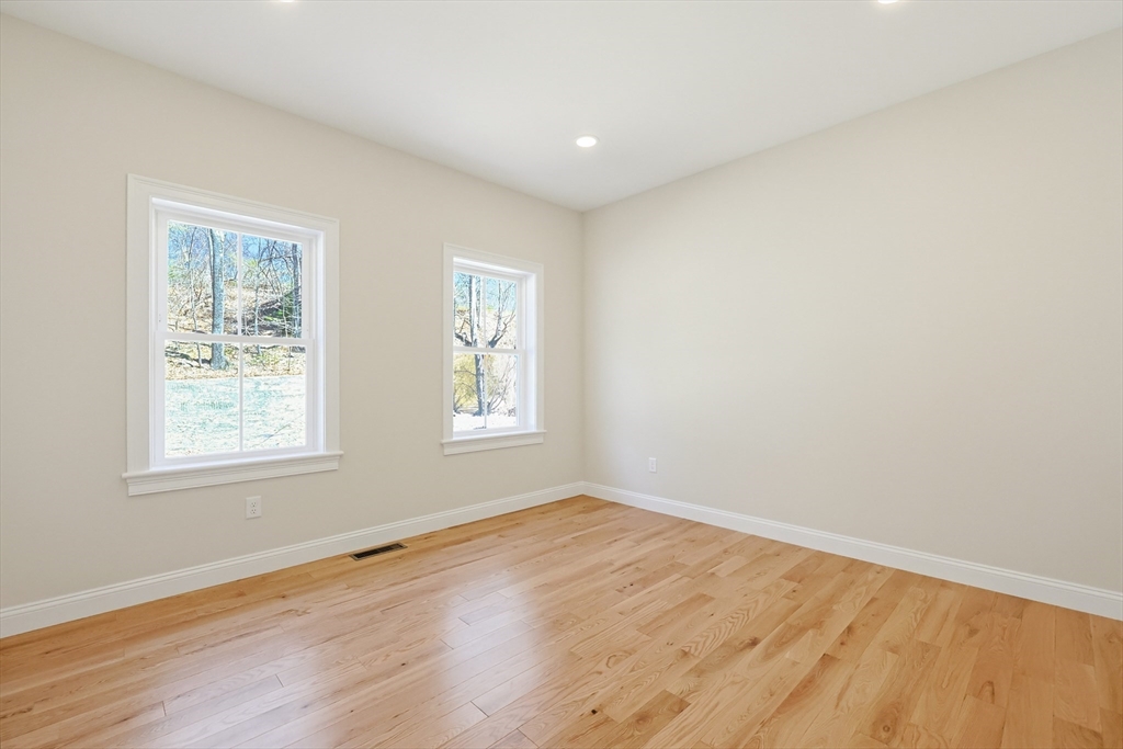 112 West Meadow Road Townsend, MA 01474 - Photo 19 of 38 an empty room with wooden floor and windows