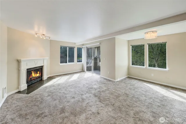 an empty room with windows fireplace and windows