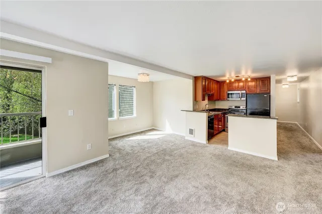 a view of kitchen with refrigerator sink and stove