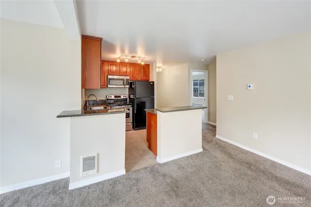 a kitchen with cabinets and a refrigerator