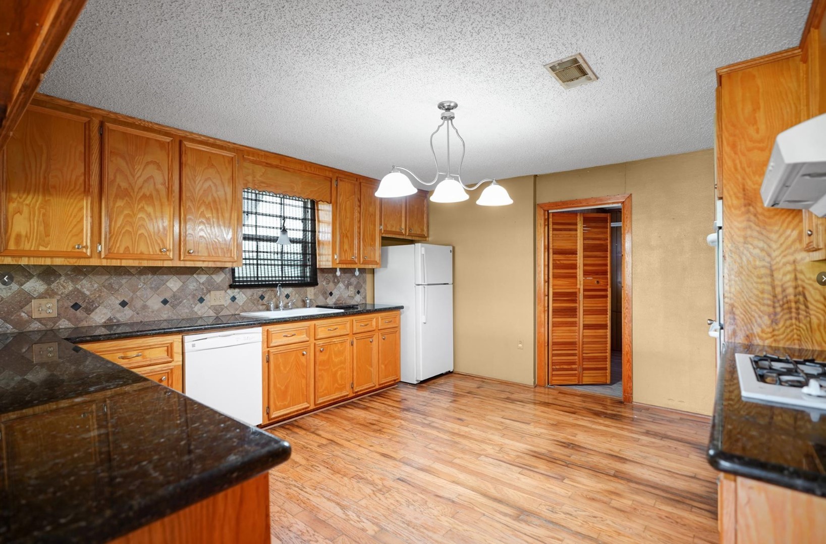 22855 East Martin Drive Porter, TX 77365 - Photo 6 of 22 a kitchen with stainless steel appliances granite countertop a sink stove and refrigerator