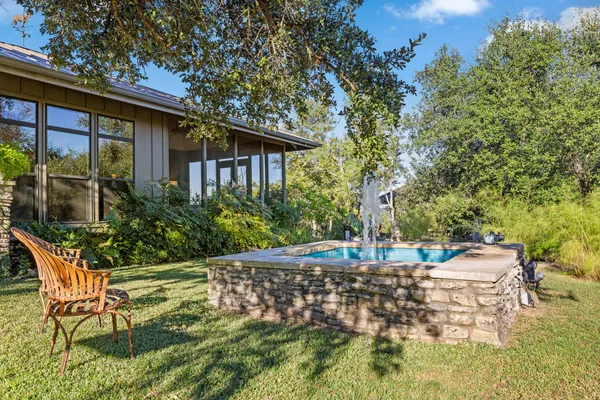 a front view of a house with a yard table and chairs