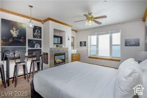 223 Hunter Road, Unit B303 Brian Head, UT 84719 - Photo 5 of 49 Bedroom with a lit fireplace and ornamental molding