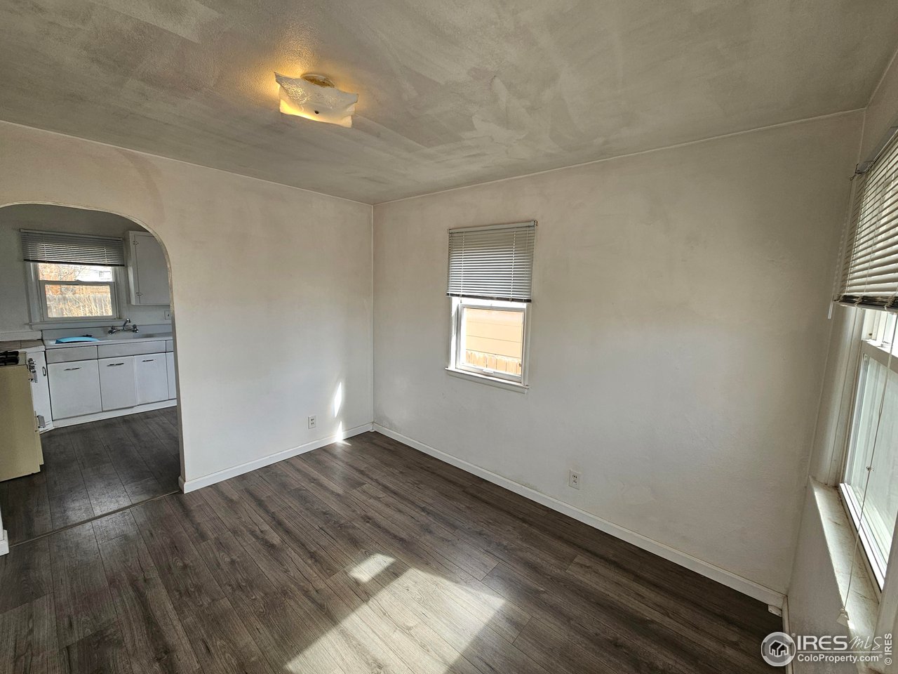 351 East 2nd Street Akron, CO 80720 - Photo 11 of 23 wooden floor in an empty room with a window