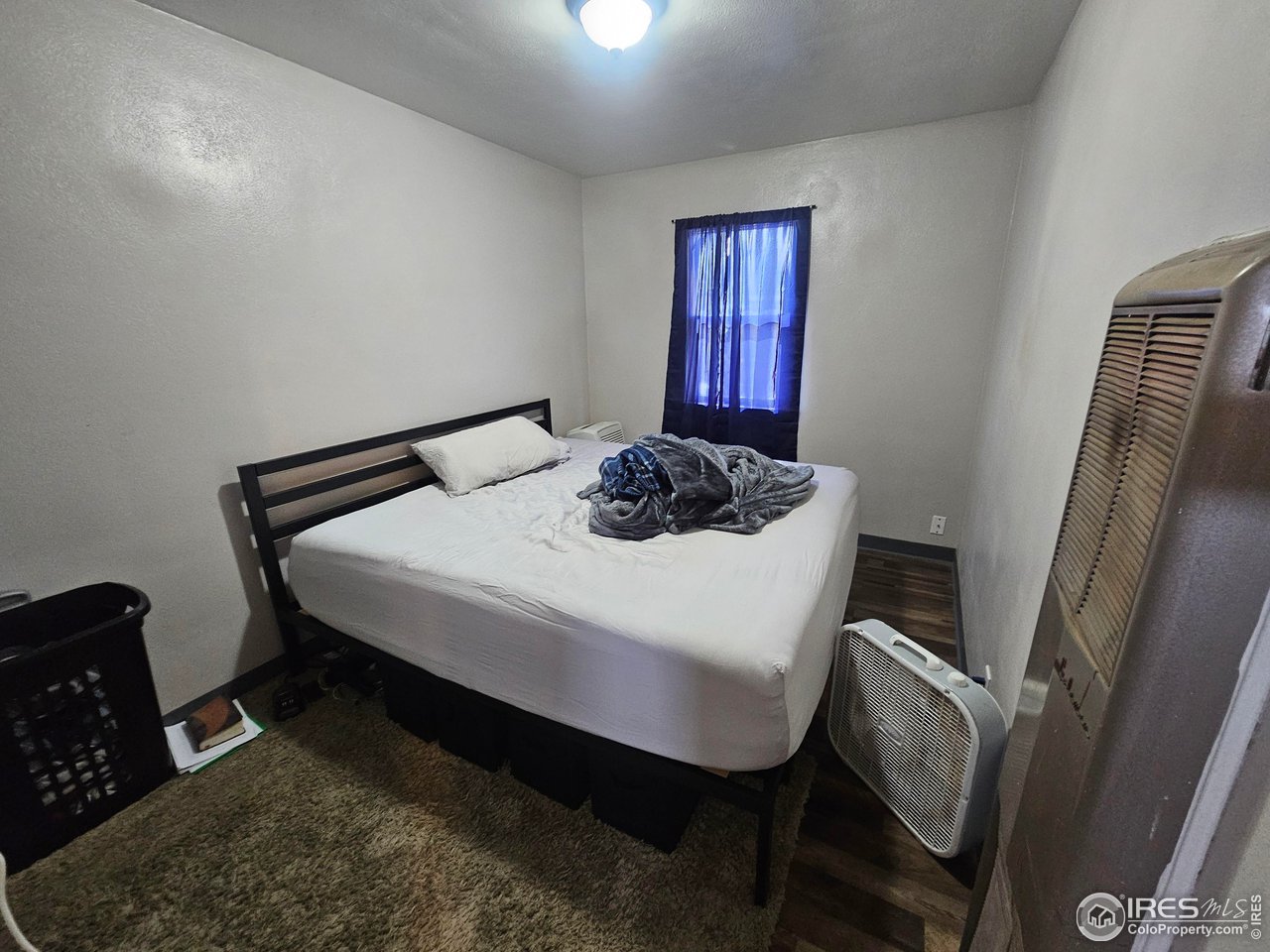 351 East 2nd Street Akron, CO 80720 - Photo 15 of 23 a bedroom with a bed and a table with rug