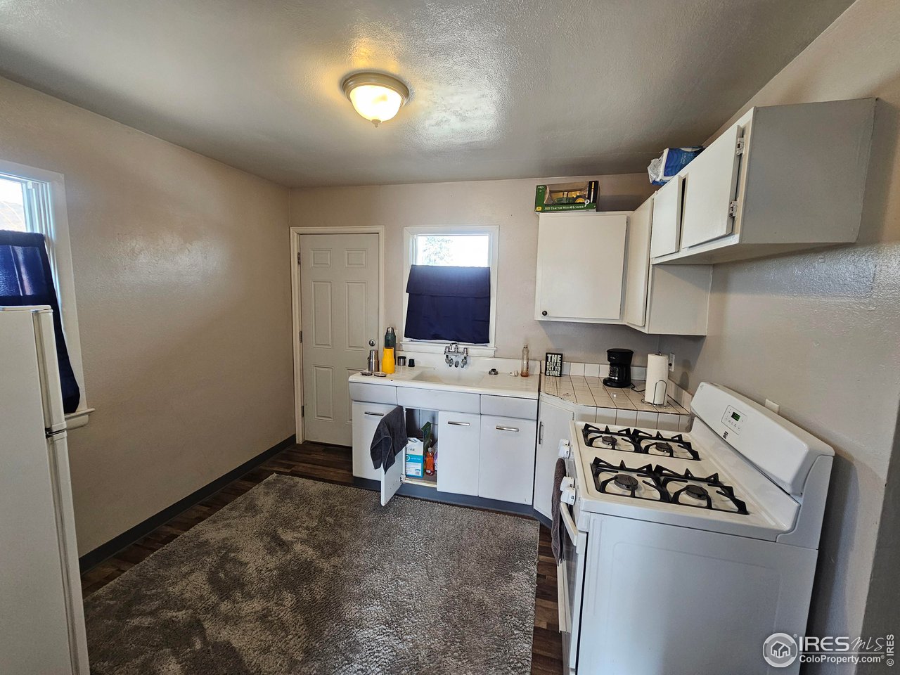 351 East 2nd Street Akron, CO 80720 - Photo 16 of 23 a kitchen with a sink cabinets and appliances