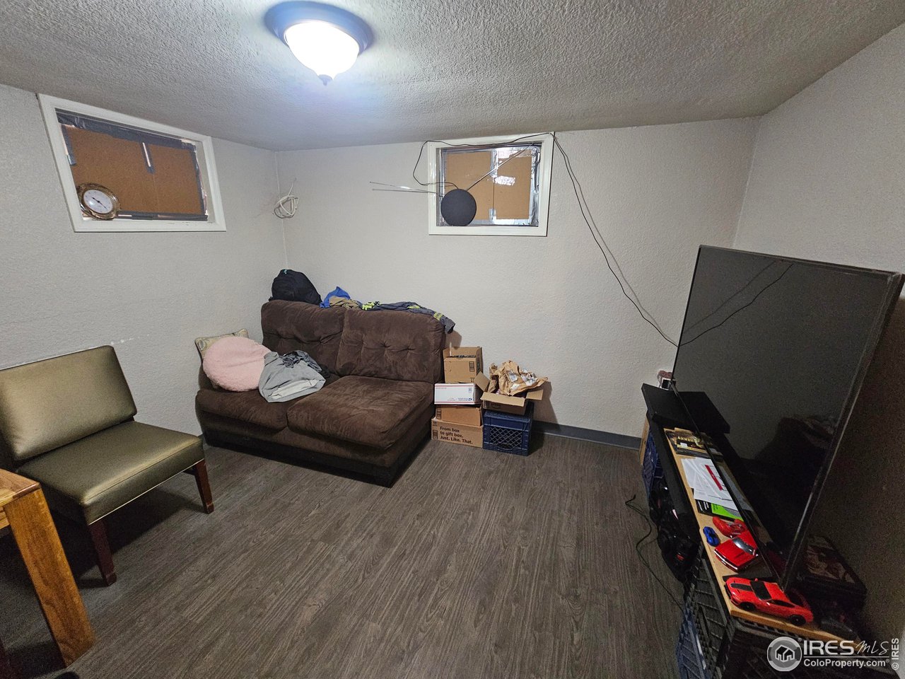351 East 2nd Street Akron, CO 80720 - Photo 7 of 23 a living room with furniture and a flat screen tv
