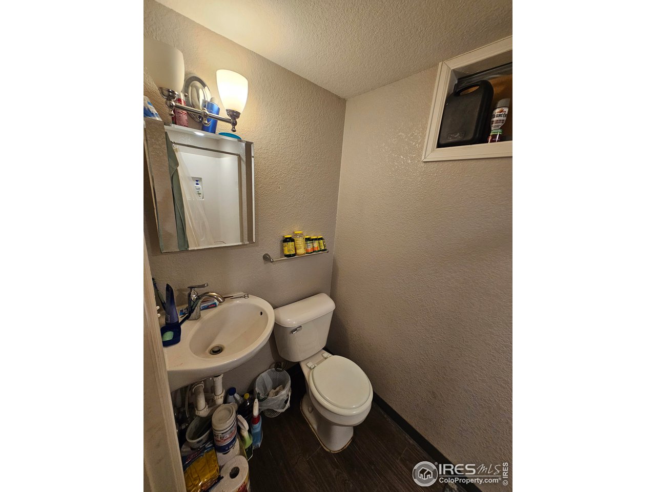 351 East 2nd Street Akron, CO 80720 - Photo 10 of 23 a bathroom with a toilet a sink and mirror
