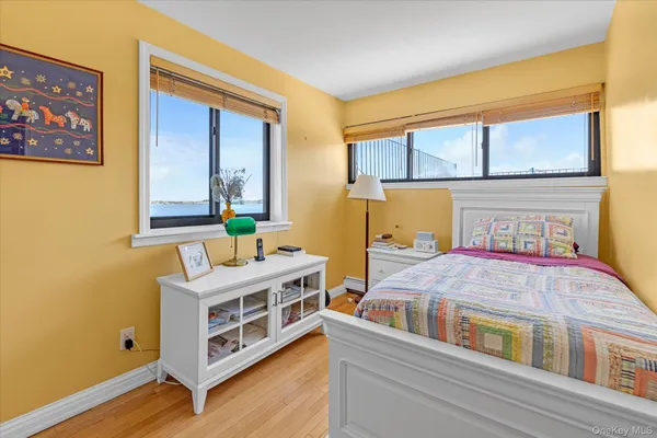 a bedroom with a bed next to a window