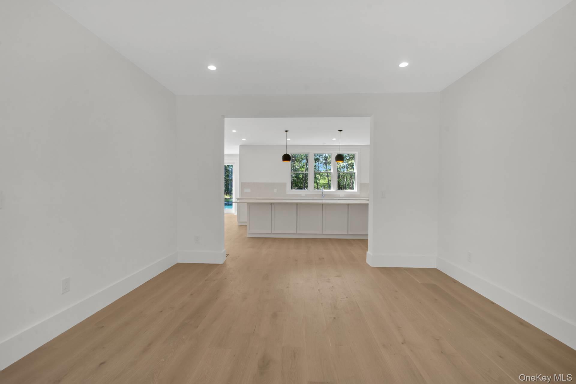 95 North Summit Boulevard Westhampton, NY 11977 - Photo 11 of 21 wooden floor in an empty room with a window