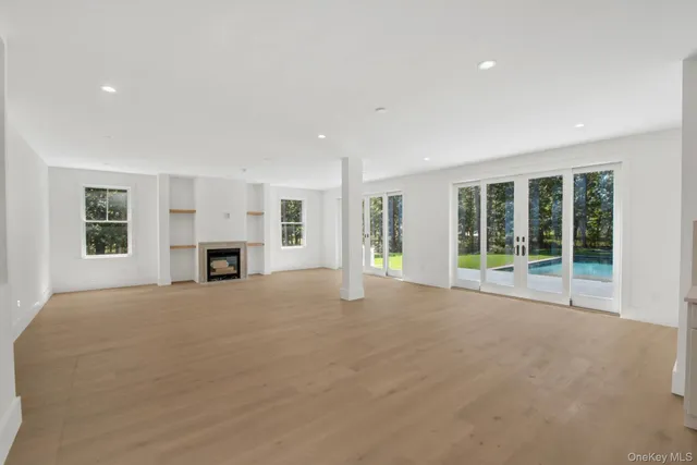 a view of empty room with a fireplace and window