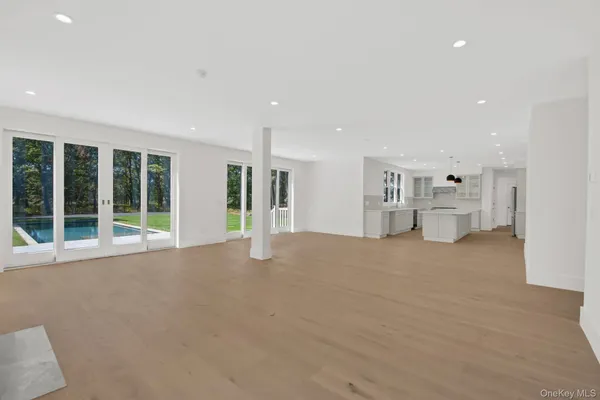 a view of a livingroom with furniture and an empty room