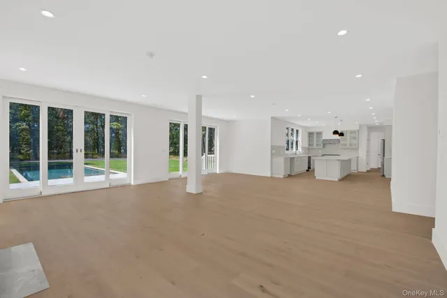 a view of a livingroom with furniture and an empty room