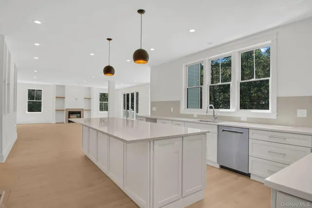 a kitchen with a sink and chandelier