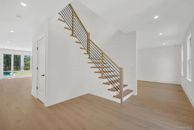 a view of entryway and hall with wooden floor