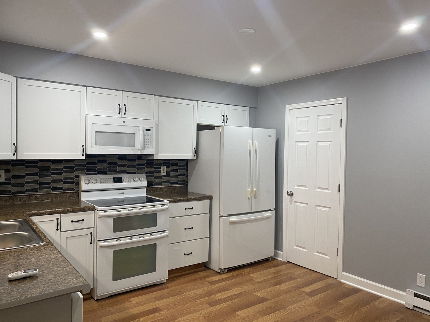 1710 Felten Road, Unit 1B Aurora, IL 60505 - Photo 11 of 14 a kitchen with a refrigerator a stove top oven and white cabinets