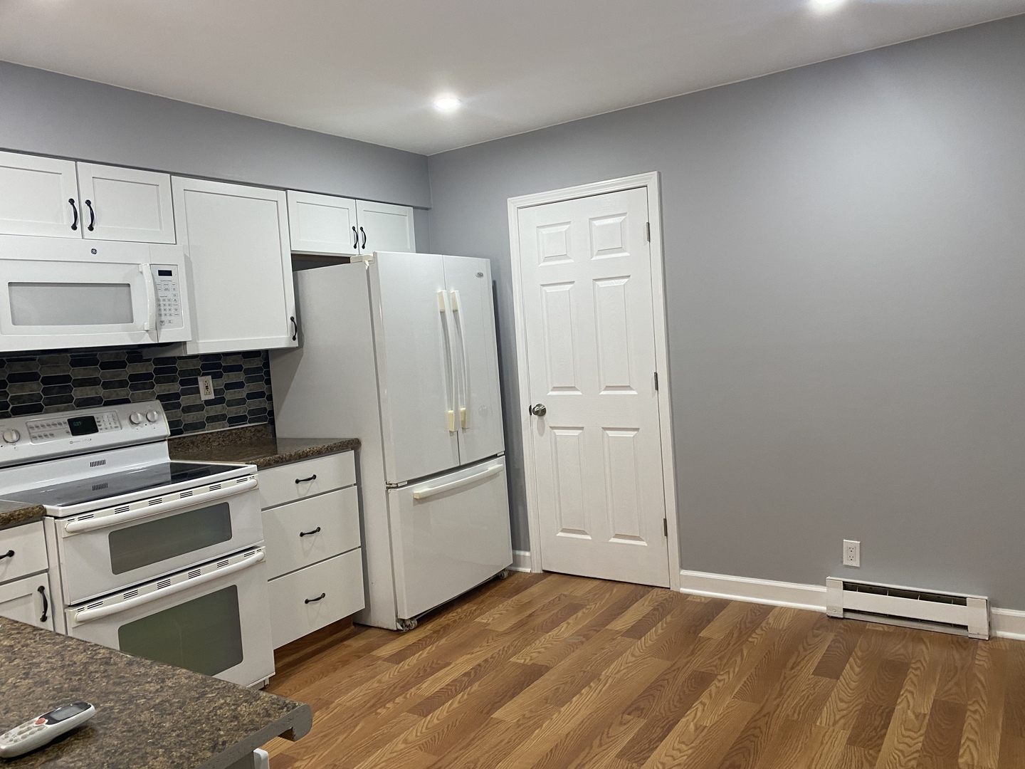 1710 Felten Road, Unit 1B Aurora, IL 60505 - Photo 2 of 14 a kitchen with white cabinets and white appliances