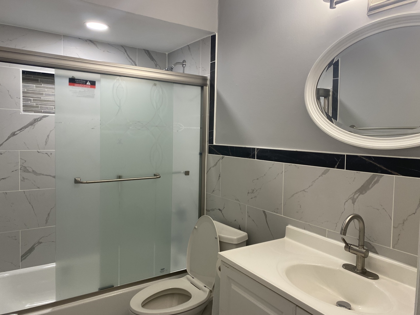 1710 Felten Road, Unit 1B Aurora, IL 60505 - Photo 3 of 14 a bathroom with a sink a toilet and shower